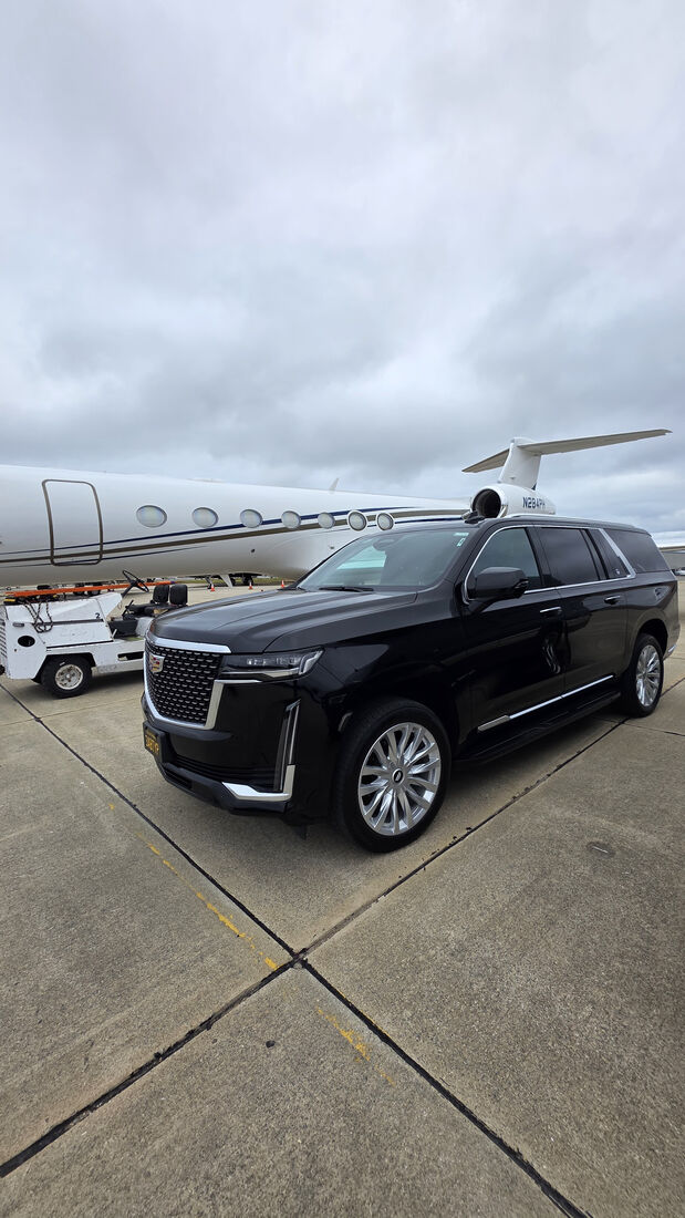 SFDRIVEN Cadillac Escalade parked beside a private jet