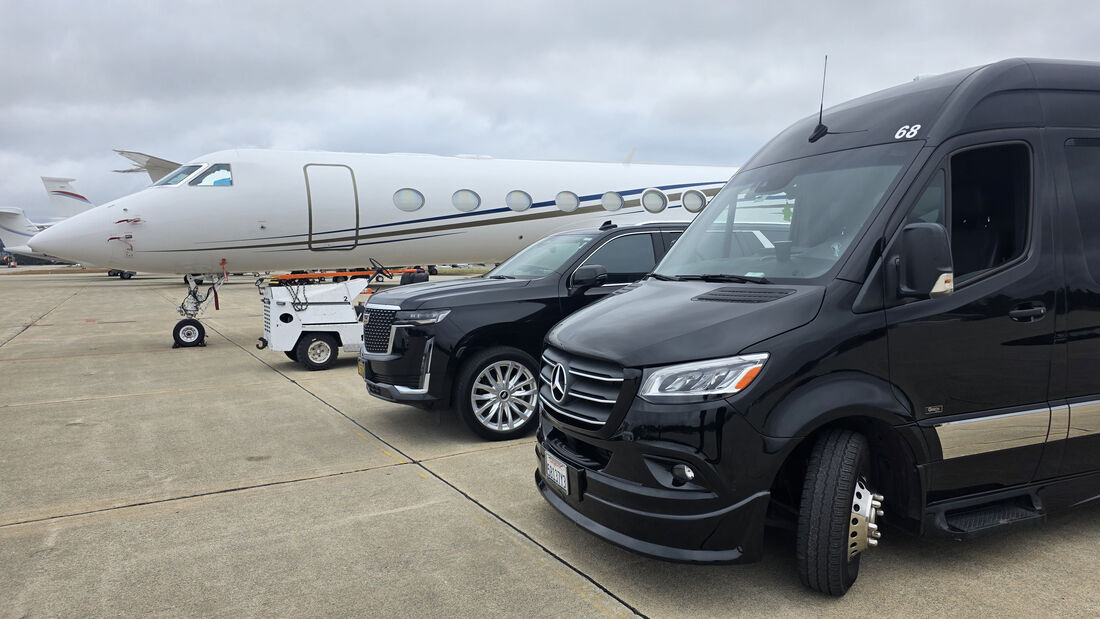 SFDRIVEN fleet vehicles parked on the tarmac beside a private jet